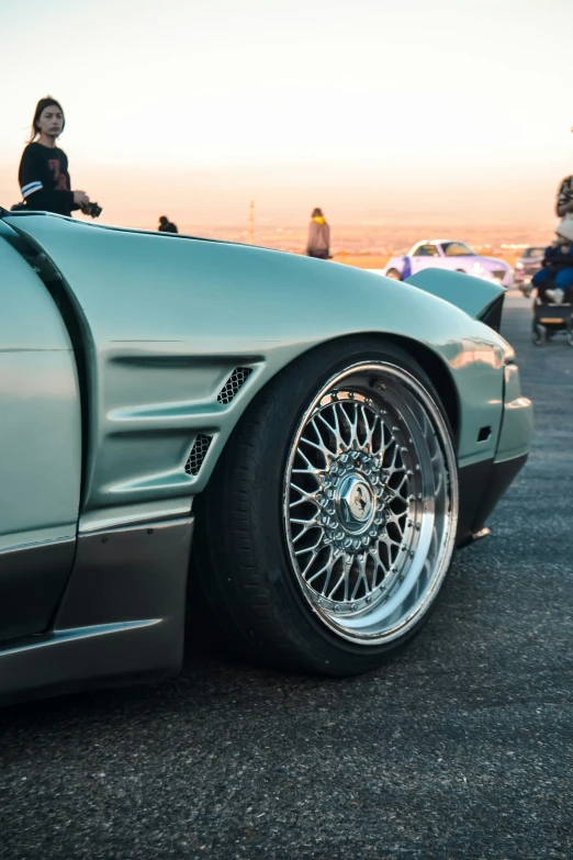 an open top sports car on display in a parking lot