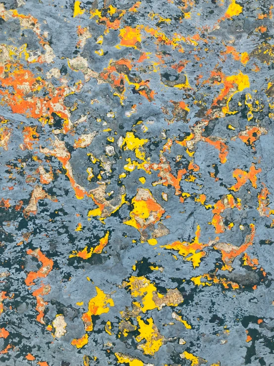 a multi - colored surface of paint with yellow and red spots