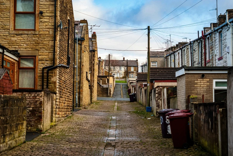 an old rundown street surrounded by brick houses