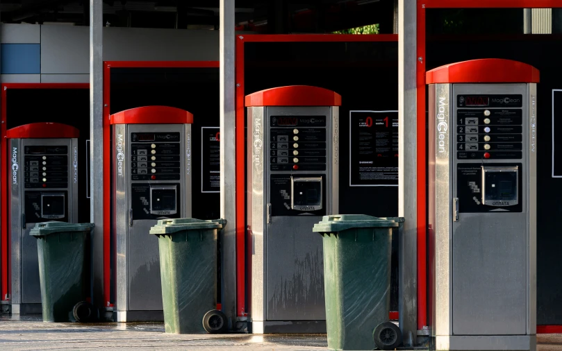 three grey and red phones are in a row