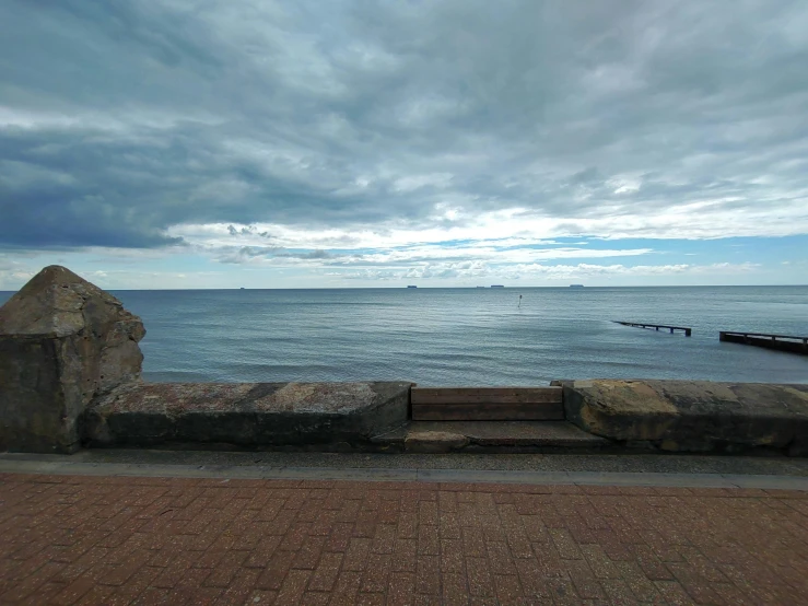 benches along the coast under cloudy skies