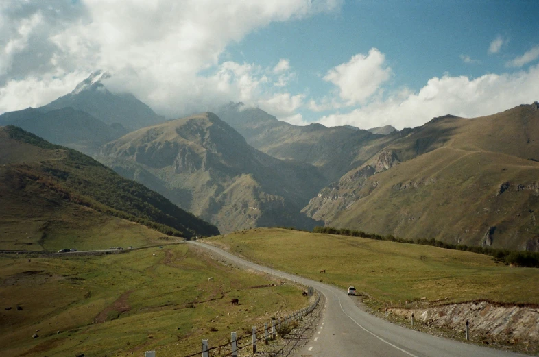 a view of a winding, mountain road from a car