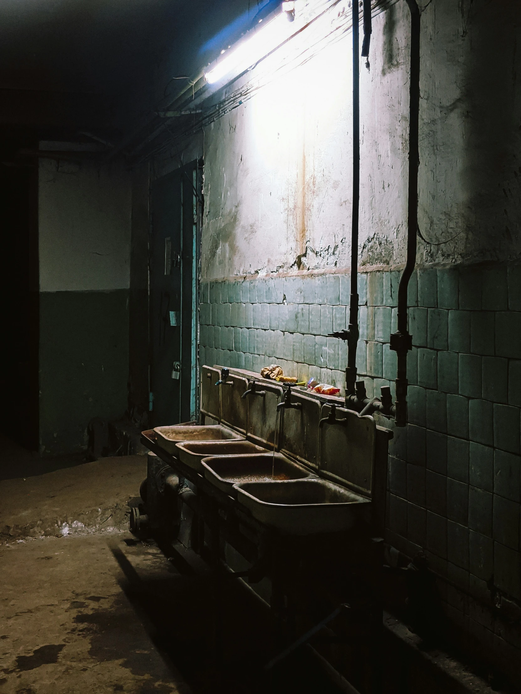 two sink in an old run down bathroom