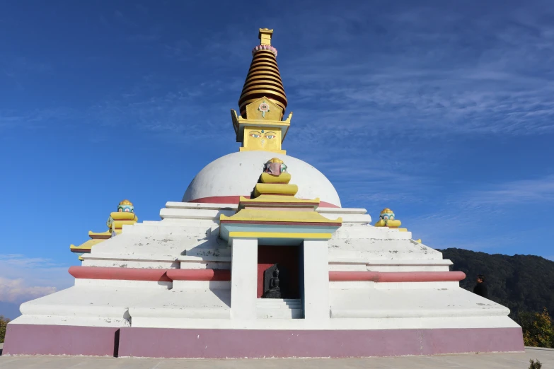 a building made of clay with a large golden spire