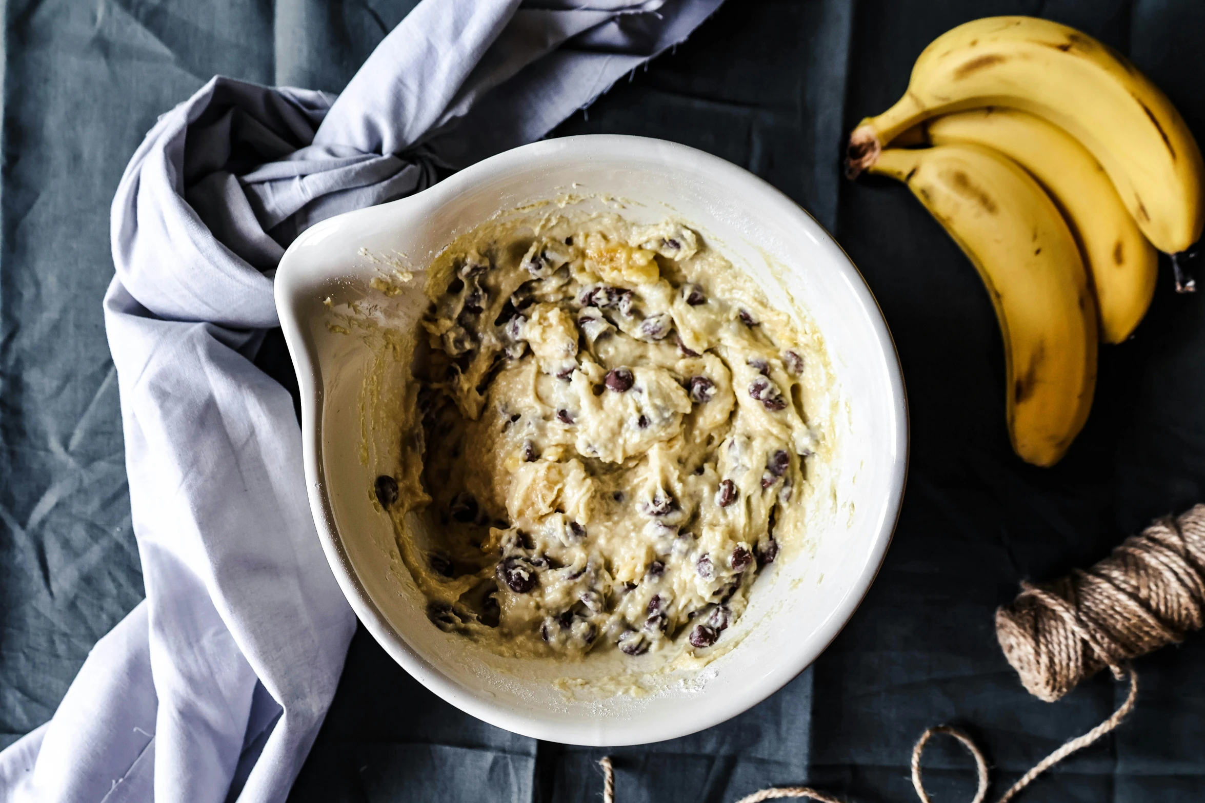 a bowl filled with food and two bananas