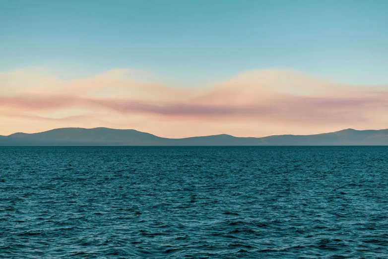 a lone boat in the middle of the ocean