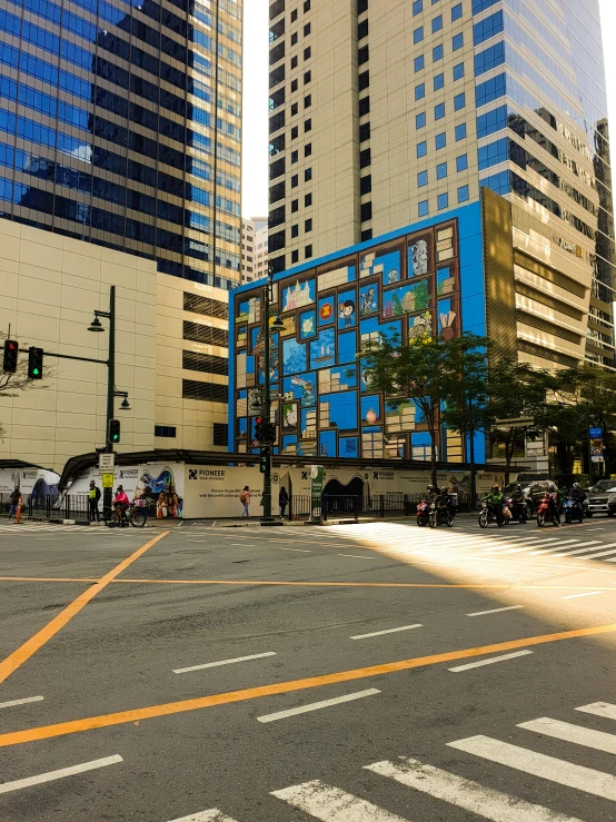 view of people walking down the street next to tall buildings