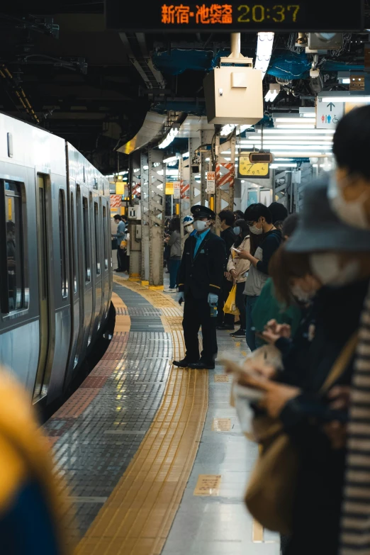 commuter train arriving at subway station with passengers waiting