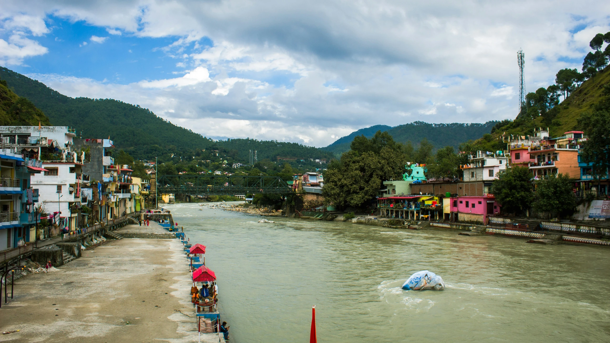 a view of a river that is running past some homes