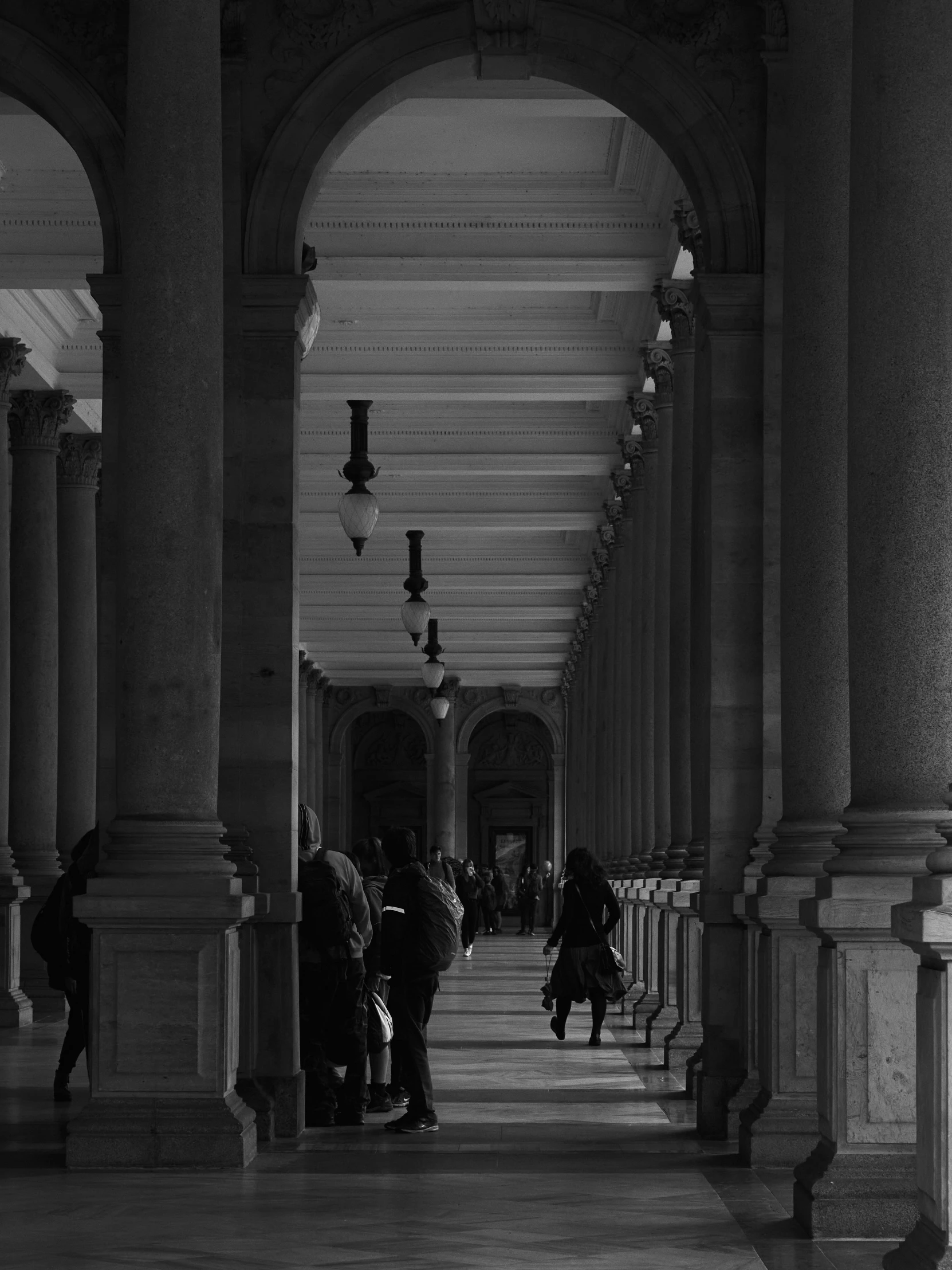 a bunch of people standing around inside a building