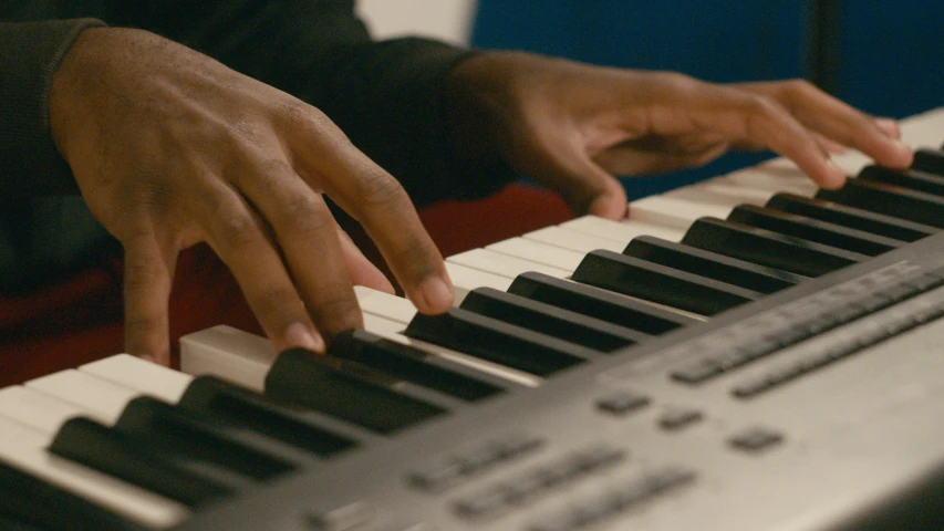 a man that is playing the piano keys