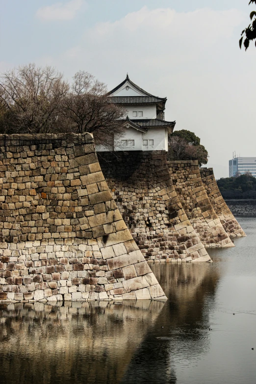 the wall along the water has a building next to it