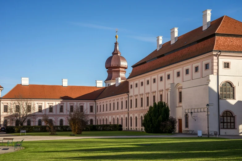 the exterior of the building with the view of a clock tower on a clear day