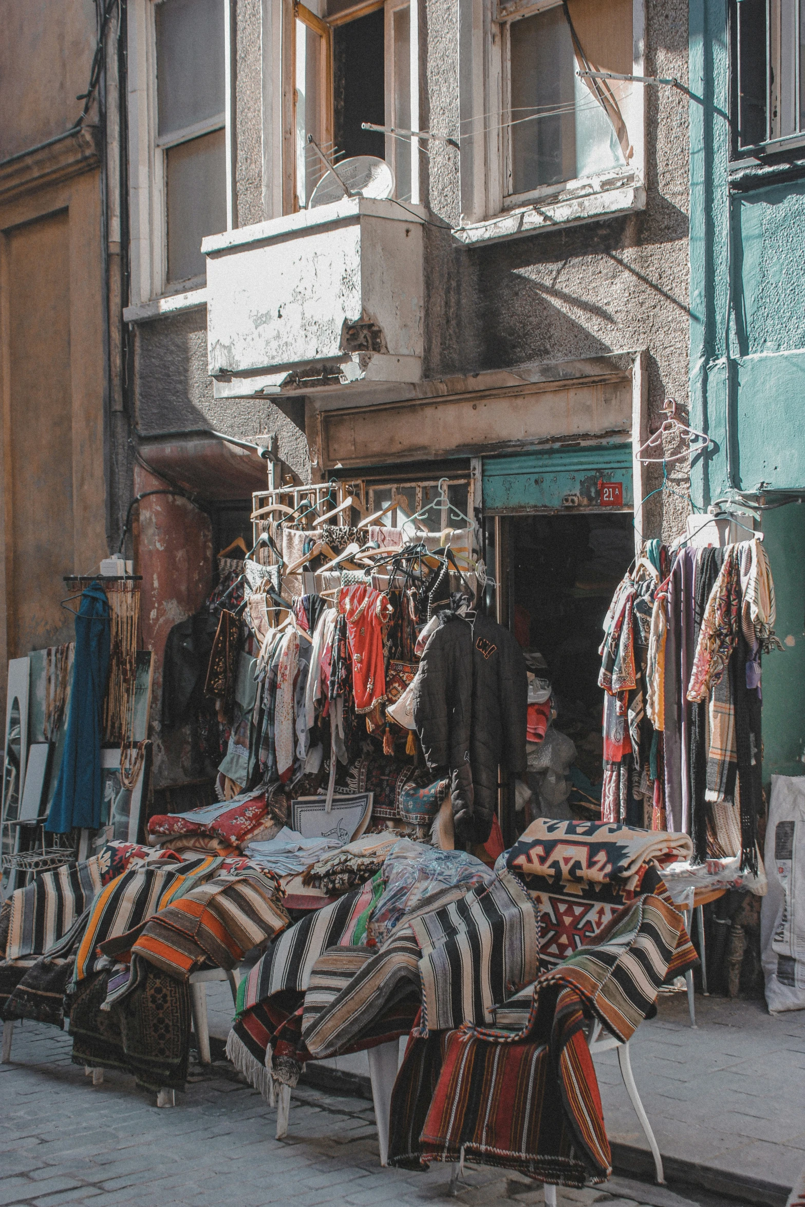 an oriental marketplace displaying fabrics and rugs