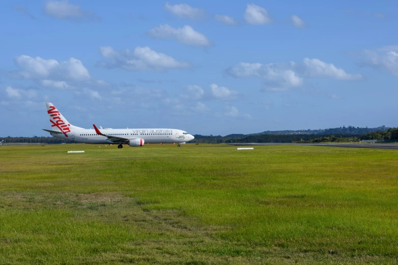 a red and white plane on the runway