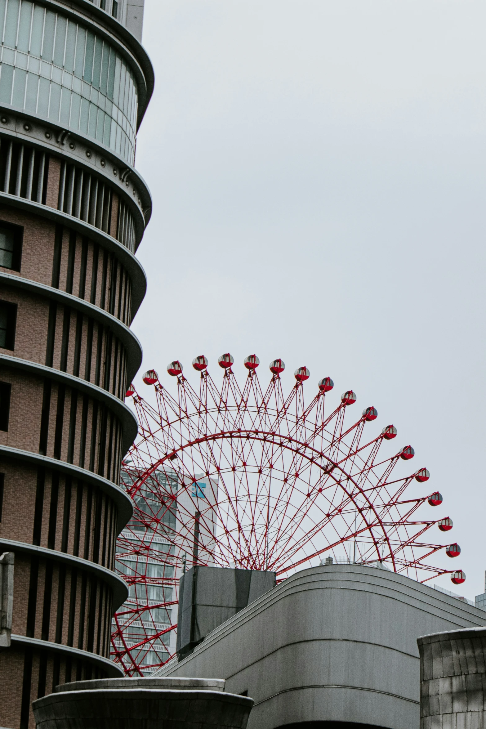 an amut attraction in the distance next to some tall buildings