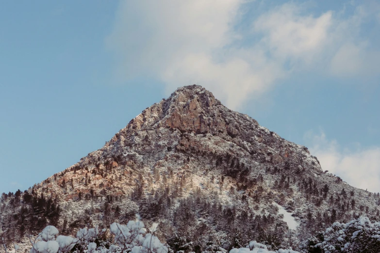 a very tall mountain with snow on the top