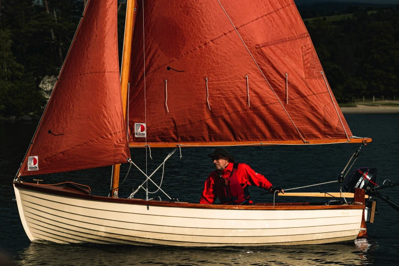 a man in red is on a sail boat