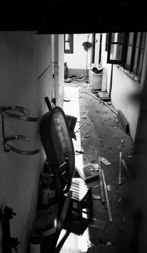 a old building with chairs and buckets and trash bags