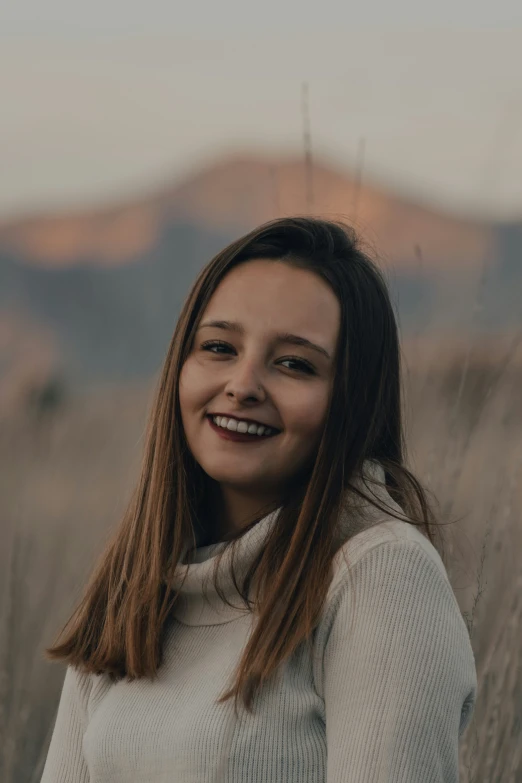 a girl with long hair smiles into the camera