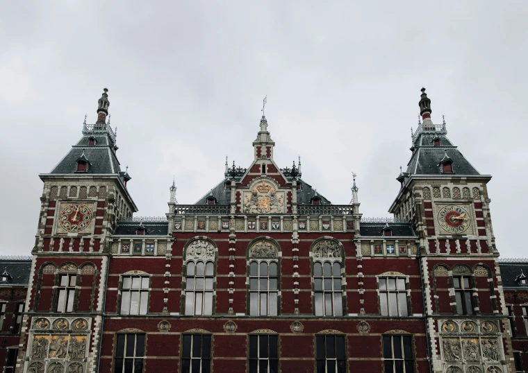 an ornate building with tall windows and a clock on the top