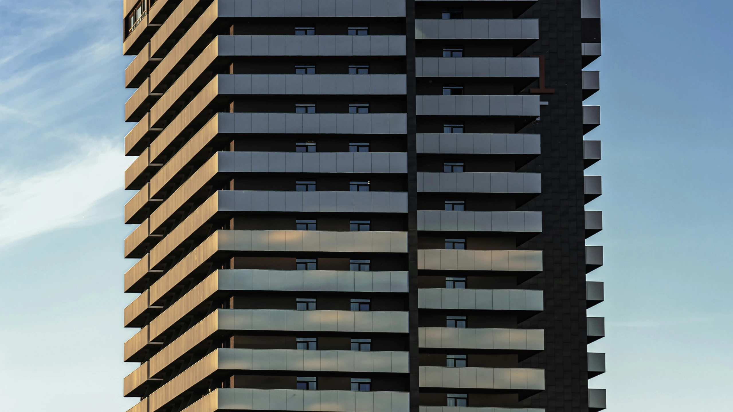 a very tall building with balconies near the top