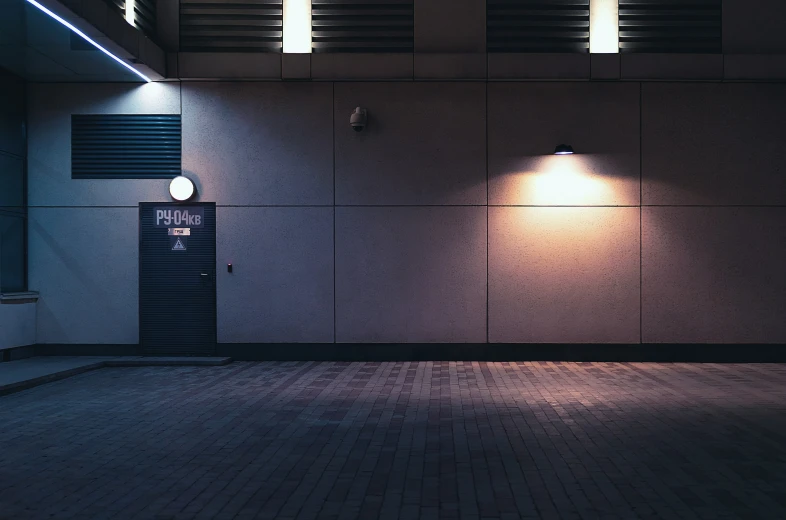 an empty room with three lights at one wall