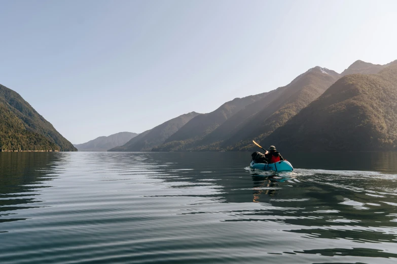 a couple in a raft paddling down the river