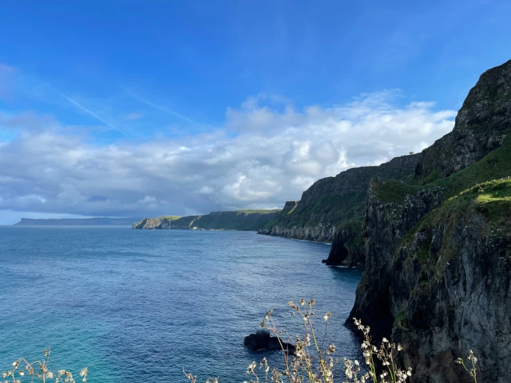 the water is blue with the cliffs on both sides