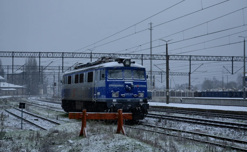 a train traveling down tracks covered in snow