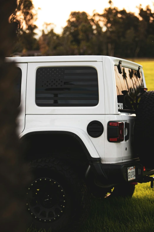 there is an all white jeep that has a rear window open