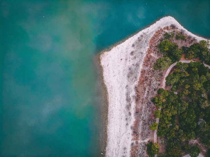 aerial s of an unkempt island in the middle of blue water