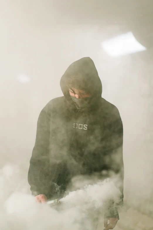 a man stands in smoke as he walks through a fog