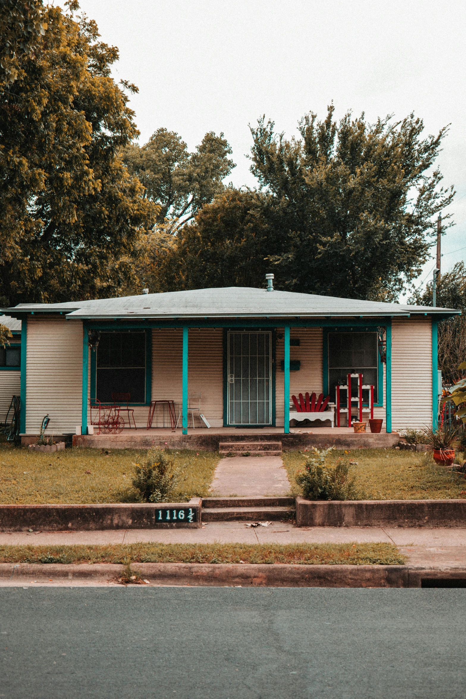 a small house sitting on the corner of the street