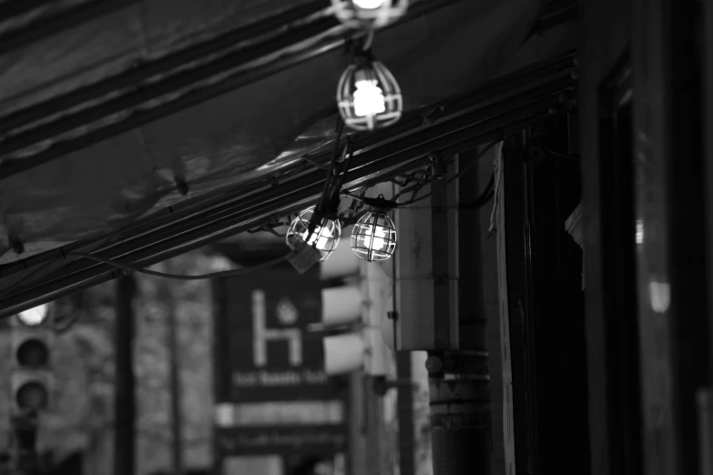 black and white pograph of a street light next to storefront