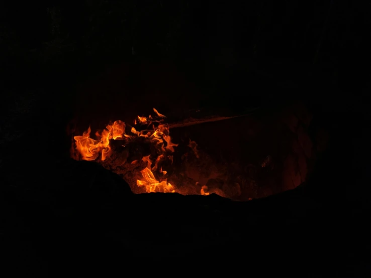 a bonfire has flames and flame sparks on a black background