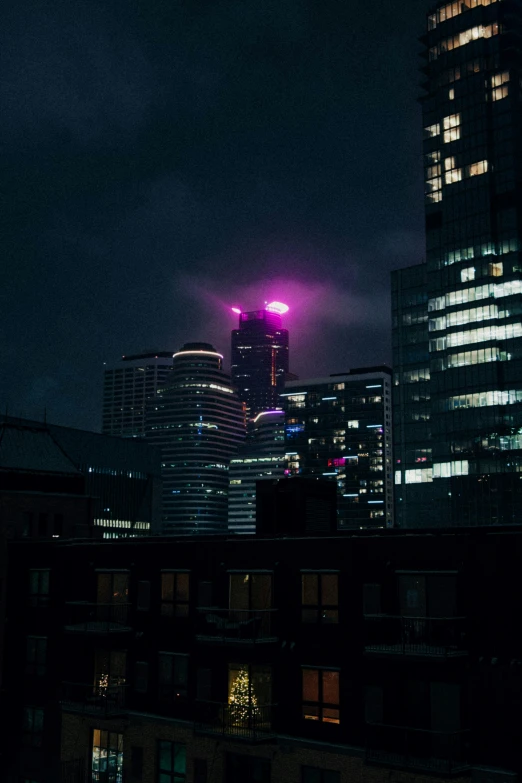 the city at night with some buildings lit up