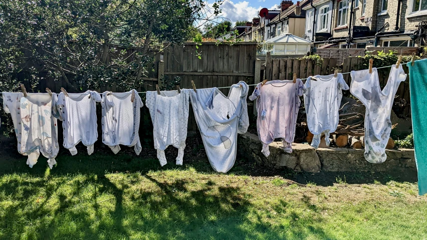 towels hanging from a clothesline on a garden in the sun