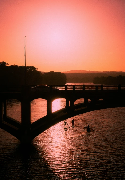 bridge over a river as the sun sets
