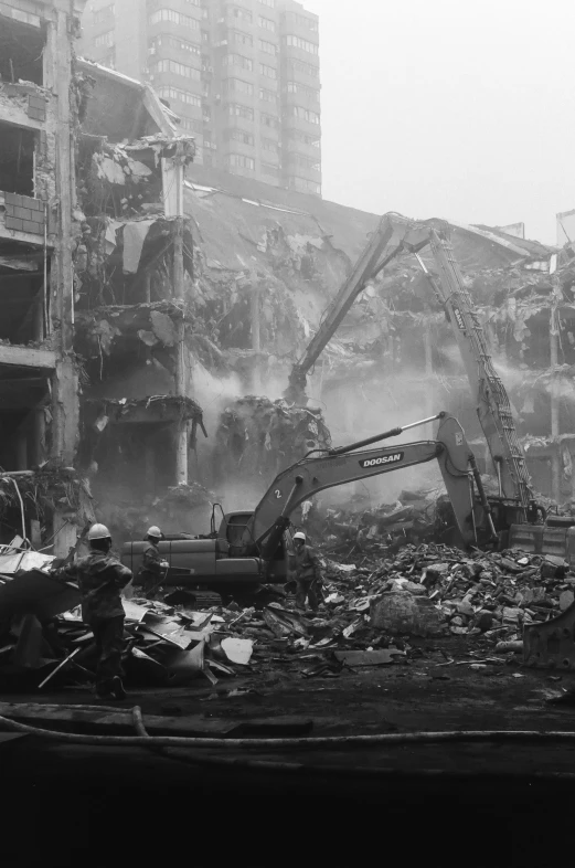 a group of workers stand in a rubble