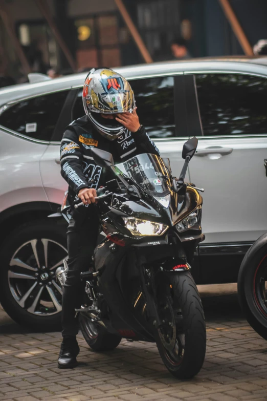 man sitting on motorcycle looking over his shoulder