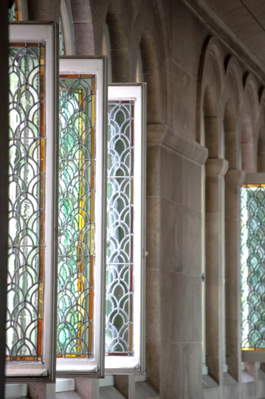 four stained glass windows in a building