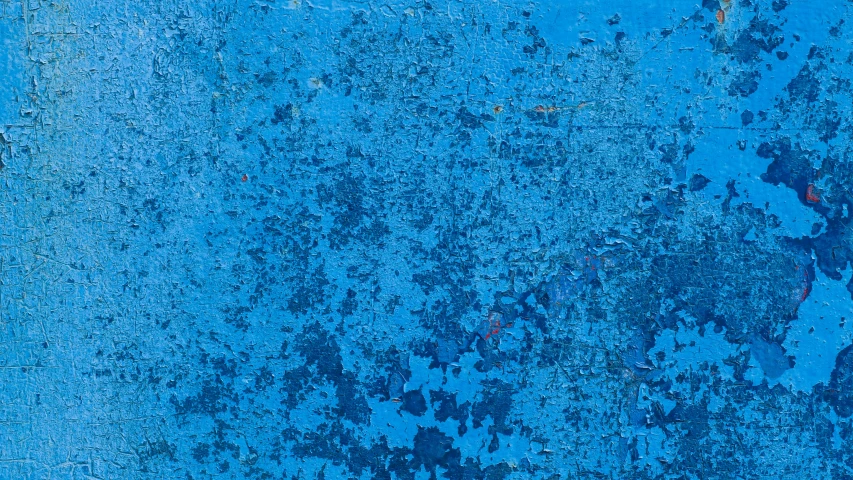 a blue wall with the colors rusted and stained