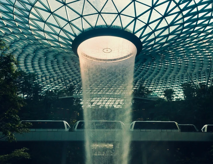 the indoor fountain has water shooting from its base