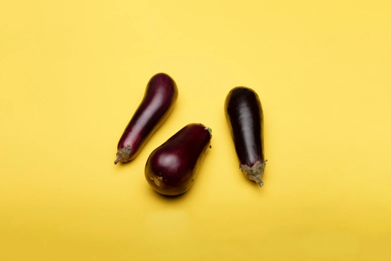 eggplant on yellow background pographed from above