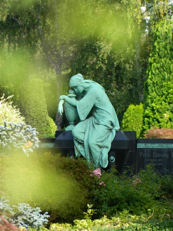 the sculpture is covering his face by his hands