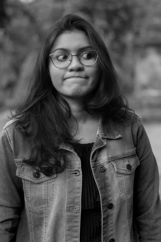 a woman in glasses looks up and smiles