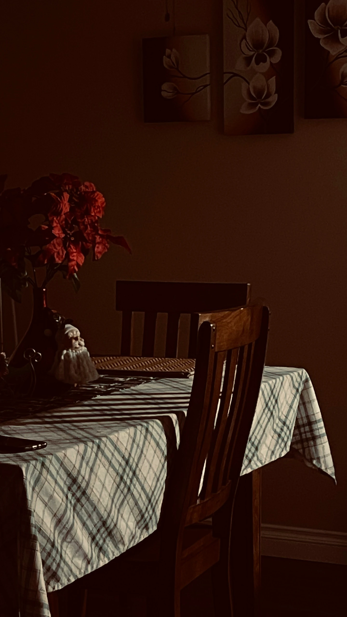 there is a dining table set with a plaid table cloth