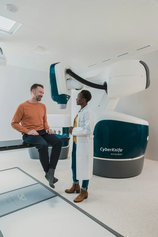 two people standing in a room with machines