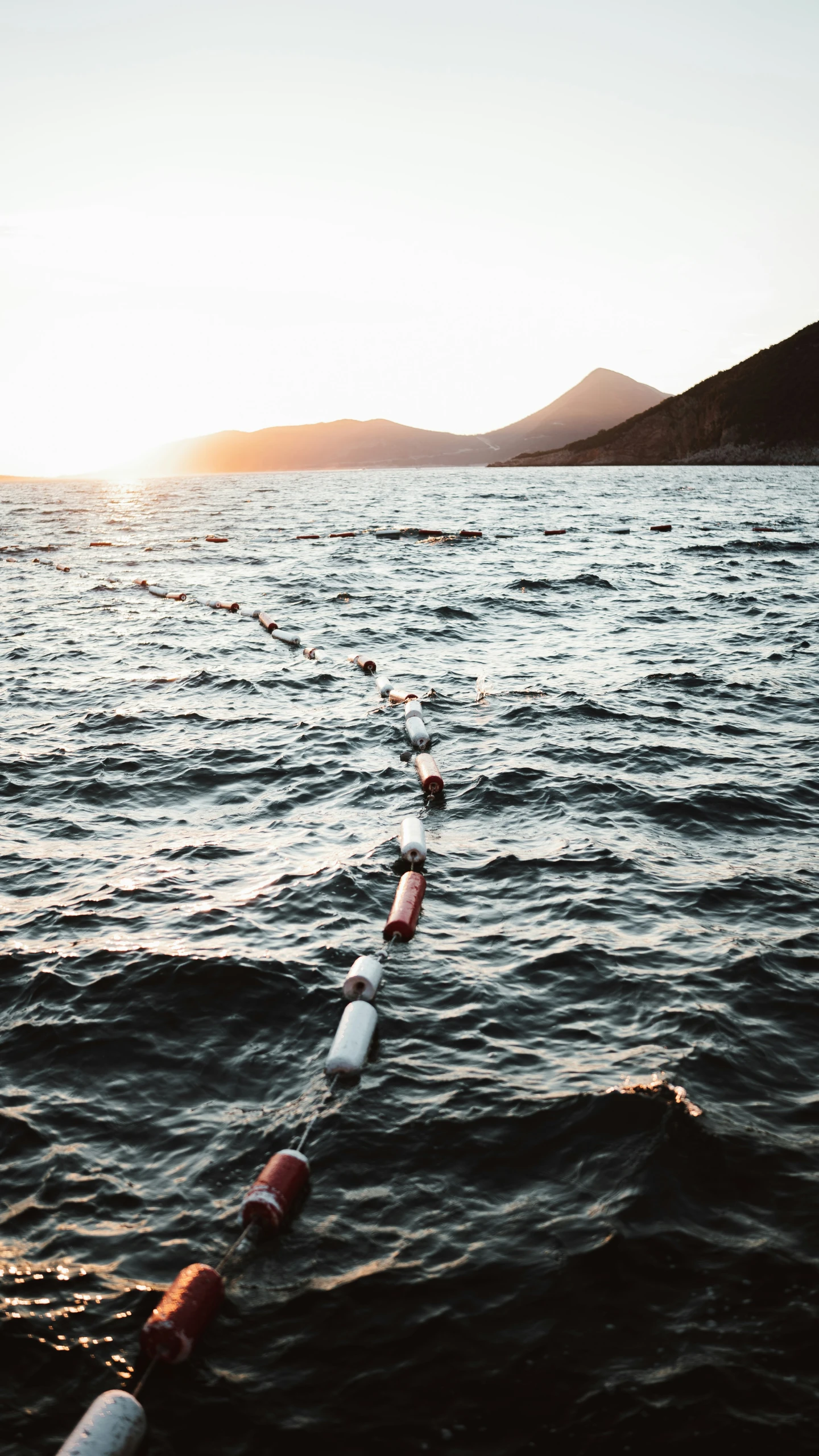 an ocean with many water vessels floating in the water